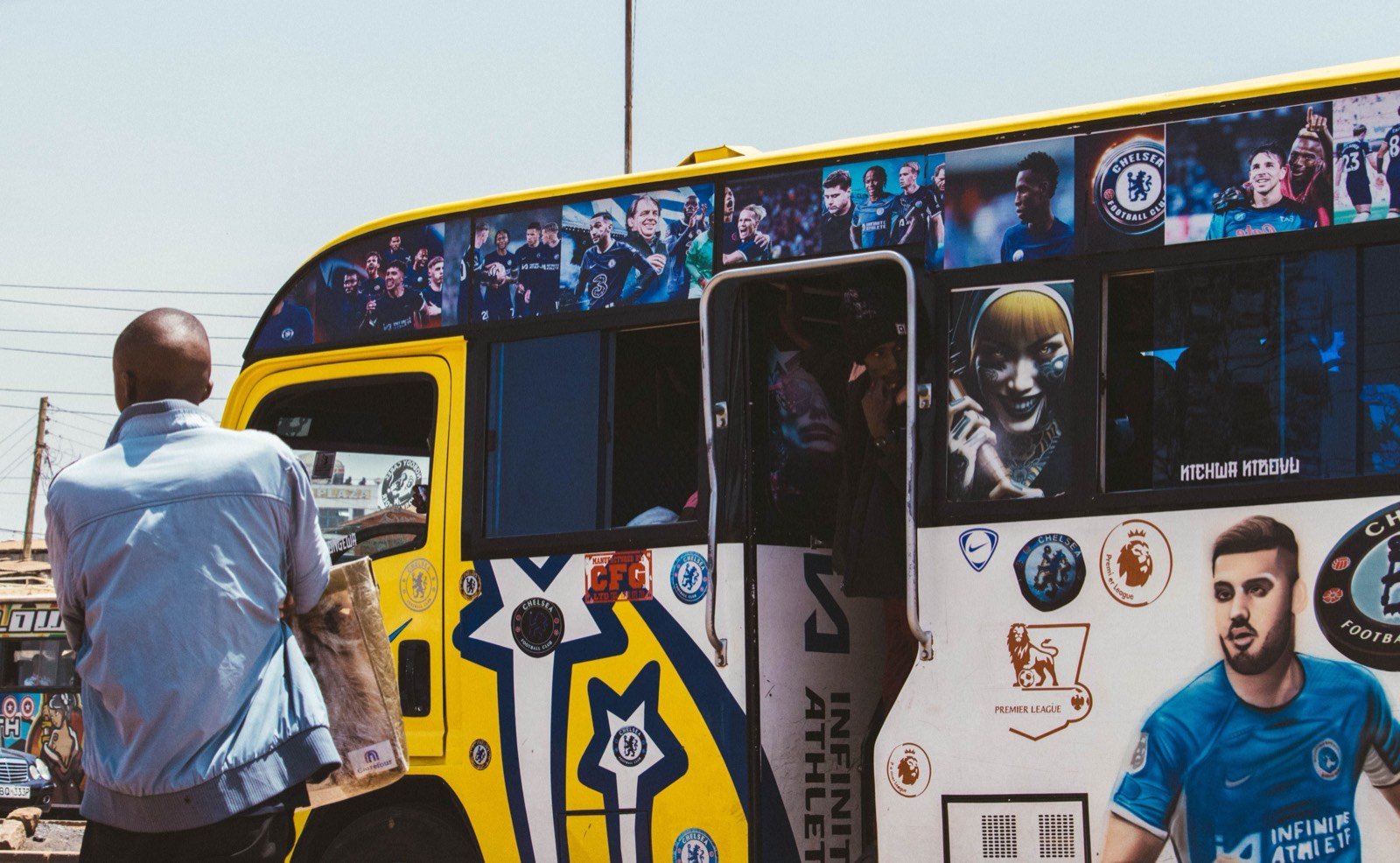 Passenger boarding a decorated matatu
